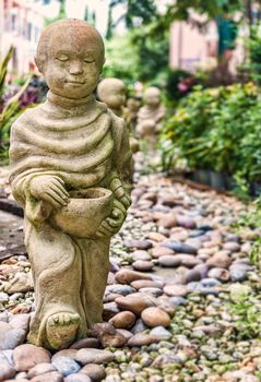 Funny traditional Thai garden monk sculpture