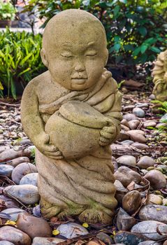 Funny traditional Thai garden monk sculpture