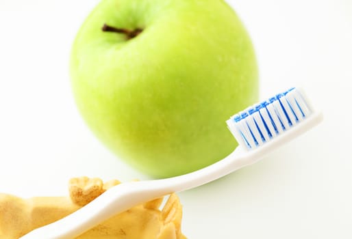 Dental health care concept, green apple and toothbrush