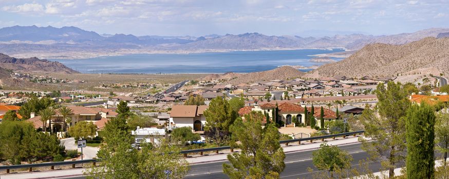 Boulder City Nevada suburbs and lake Meade with surrounding mountains panorama.