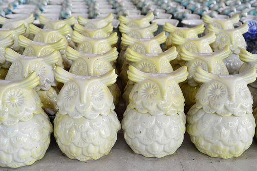 Variety of owl Ceramic Pots in an Outdoor Shopping Market.