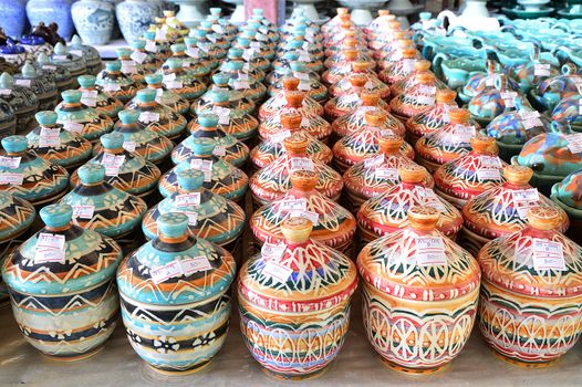 Variety of Colorfully Painted Ceramic Pots in an Outdoor Shopping Market.