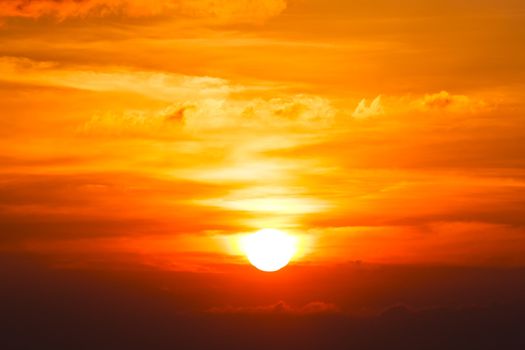 Brilliant orange sunrise over clouds in Iowa with bright yellow sun