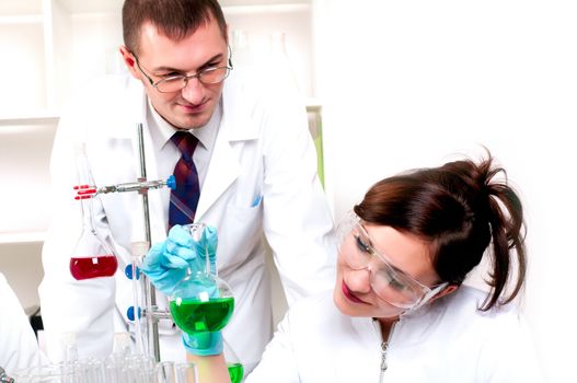 Chemists working with a team looking at the tube