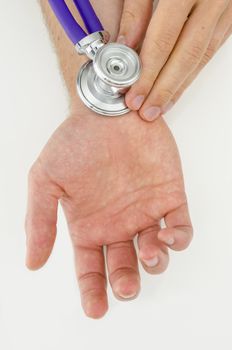 Detail of holding stethoscope on male hand.