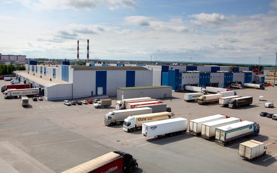 ST-PETERSBURG, RUSSIA - JUNE 13: Loading and unloading in a large warehouse complex, June 13, 2013. Trucks waiting to unload warehouse terminal.