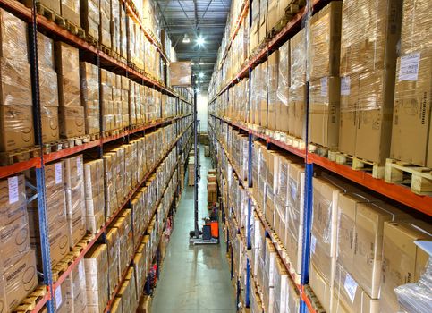 ST-PETERSBURG, RUSSIA - JUNE 13: Storage of goods in a large warehouse complex, June 13, 2013. High bay storage of goods in a modern warehouse. Shelves with boxes of stock? large warehouse, modern warehouse