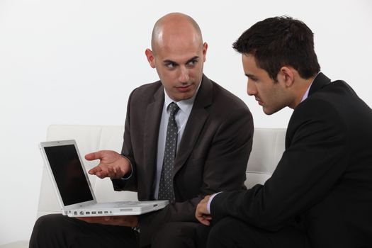 Businessman explaining his work to colleague