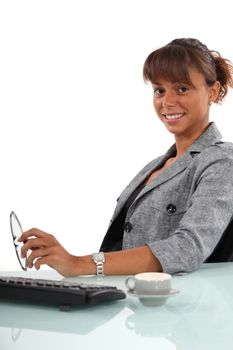 Brunette sat at her desk