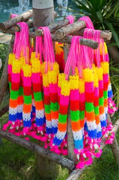 Multi color artificial garlands hang around the tree