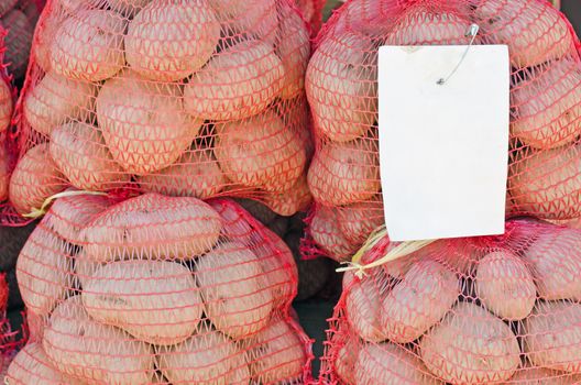 Potato Sacks with Blank Price Tag on Farmers Market, horizontal shot