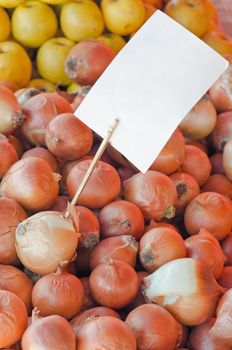 Pile of White Onion with Blank Price Tag on Farmers Market, Angled Vertical shot
