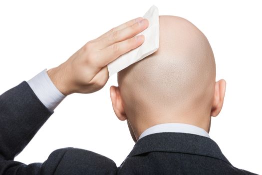 Tired or upset businessman wiping or drying bald sweat head with handkerchief or tissue