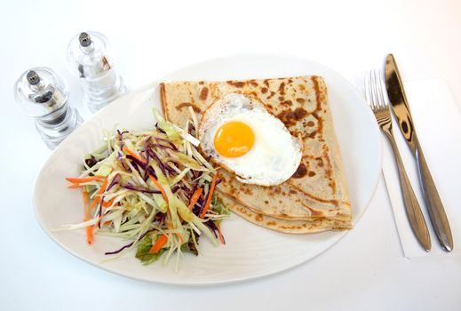 Fried eggs with coleslaw served for delicious brunch