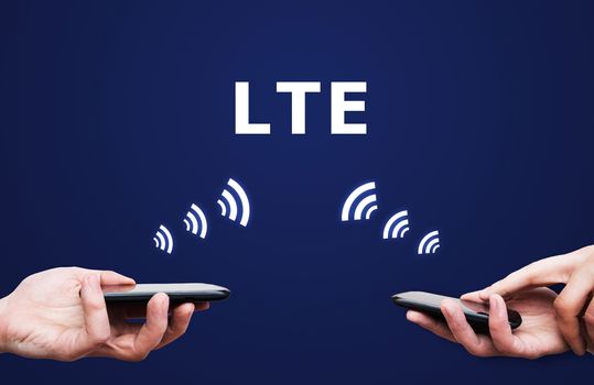 LTE high speed mobile internet connection. Hand holding cell with streaming data