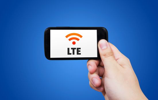 LTE high speed mobile internet connection. Hand holding cell with streaming data