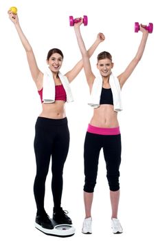 Girls in gym working out together. Eat healthy, stay fit