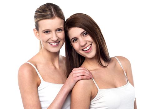 Smiling attractive friends wearing sleeveless spaghetti and posing