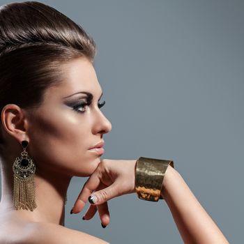 Beautiful young caucasian woman with evening makeup and hairstyle