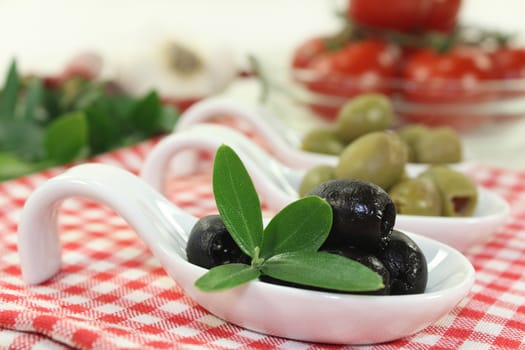 Olives with olive leaves on a spoon