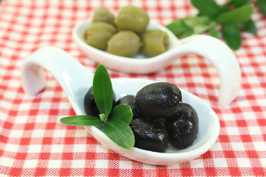 Olives with olive leaves on a spoon