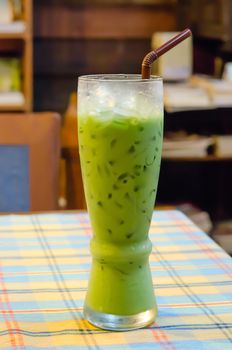 iced milk  green tea with straw  on table