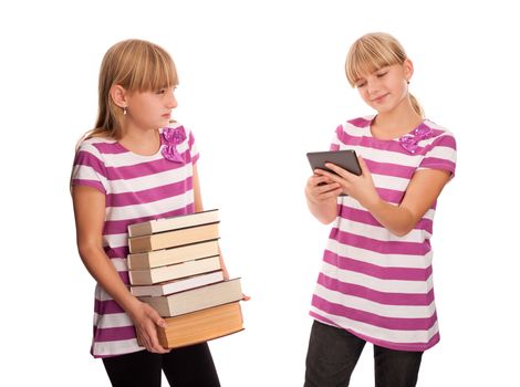 Books vs ebook reader - One girl holding lots of books and watching enviously another girl reading an ebook reader and smiling.