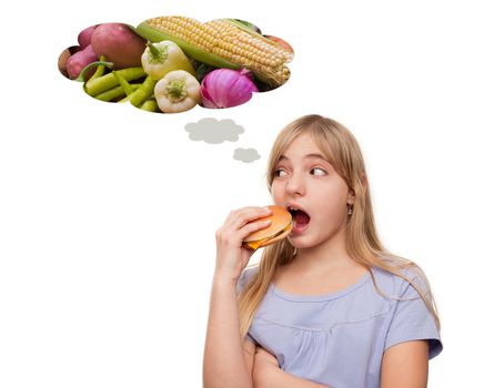 Girl eating a hamburger while thinking of vegetables. Isolated on white.