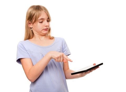 Girl trying a tablet mistrustfully. Isolated on white.