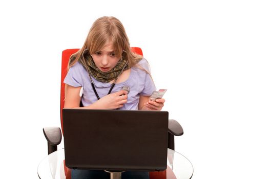 Hypochondria - Young Female checking herself with a stethoscope and searching information about her disease on a laptop.