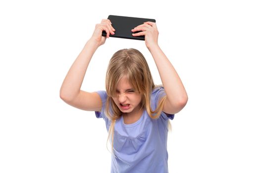 Angry teen girl pissed off with her tablet so she flooring it. Isolated on white.