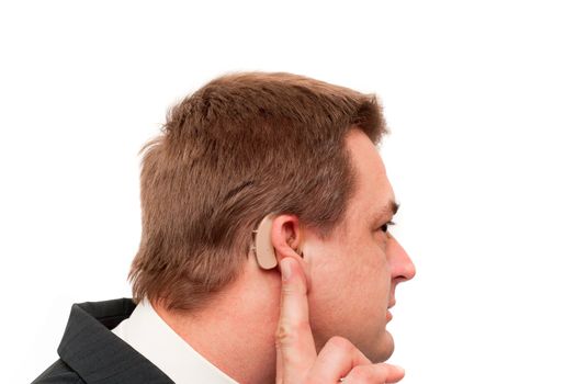 Deaf man showing his behind-the-ear hearing aid. Isolated on white.