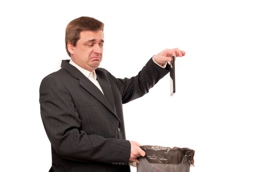 Useless tablet -  Disappointed businessman throwing a tablet in the recycle bin.