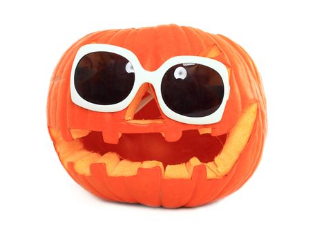 Halloween pumpkin wearing sunglasses - isolated on white