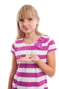 Nice teen girl holding a hearing aid in front of a white background.