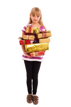 Teenage girl holding lots of christmas presents in front of a white background.