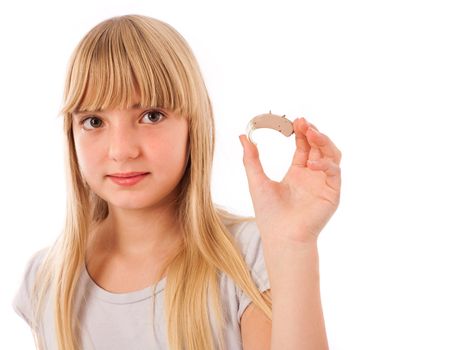 Girl showing a hearing aid. Isolated on white.