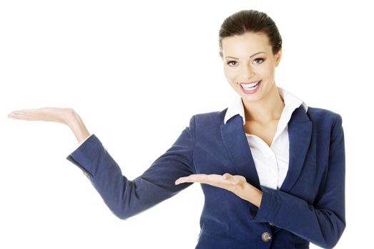 Happy young business woman showing copy space on her palm, isolated on white