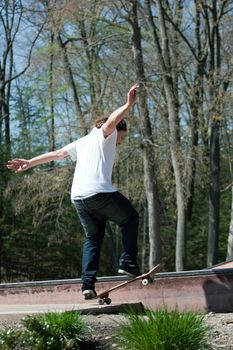 Action shot of a skateboarder skating on a rail at the skate park.