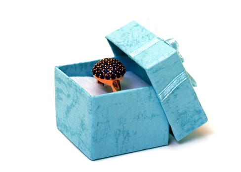 Cyan gift boxes with ring closeup on white background