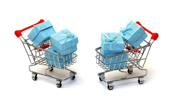 Cyan gift boxes in shopping carts on white background