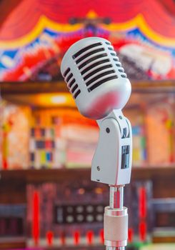 Classic microphone on colorful blur background
