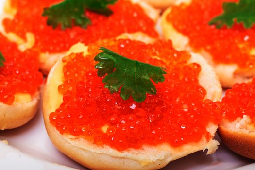 Sandwiches with red salted caviar, on a white background