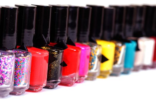 Group of bright nail polishes on white background