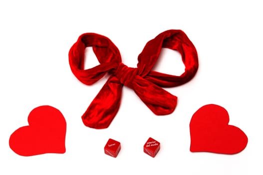 red ribbon with hearts and love dice on white background