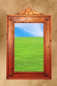 ancient carved wooden frame with idyllic natural photo on it - could be a window