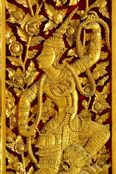 Thai woodcarving angle painted with golden color a;ways found at temple or palace's door