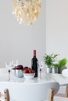 Elegant dining room decorated with beautiful chandelier and plants.