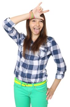 Teenage girl shows tongue and makes hand horns. Mint-colored pants and a plaid shirt. One person, teenager, female, caucasian appearance, isolated image on a white background.