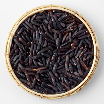 Thai black jasmine rice (Riceberry)in bamboo basket isolated on white
